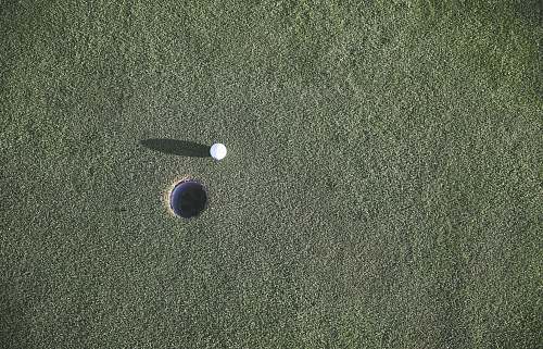 ball white golf ball near hole sport